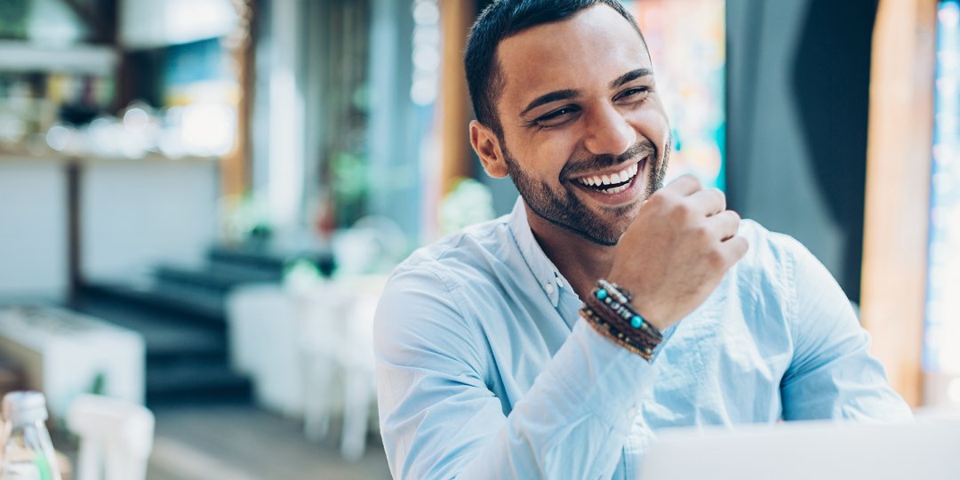 A smiling professional symbolizes positive outlook goals for Door Supervisors in the New Year.