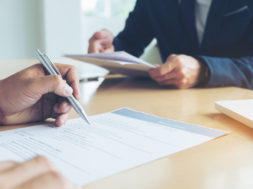 Executive reading a resume during a job interview and businessma