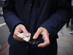 man putting in or taking off money from his wallet