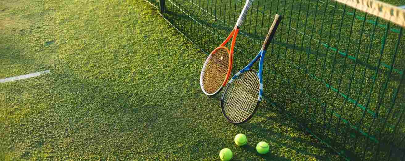 two tennis racquets placed side by side on the court