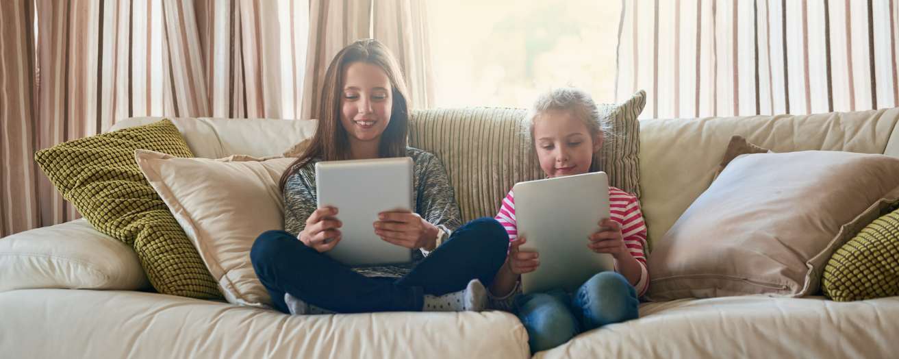 two children using tablets